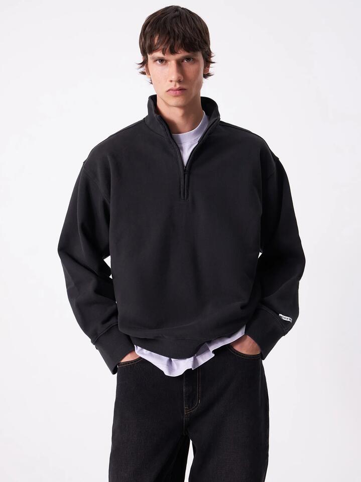 Image of a model wearing Outerwear. Productname: Article One Article Rose 1/4 Zip in Washed Black colour by brand - Article One