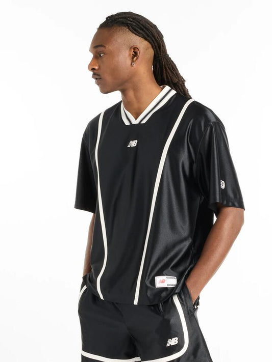 Image of a model wearing Tops. Productname: New Balance Hoops Shooting Top in Black colour by brand - New Balance