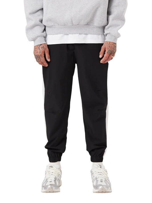 Image of a model wearing Pants. Productname: Zanerobe Sureshot Tech Jogger 2.0 in Black colour by brand - Zanerobe