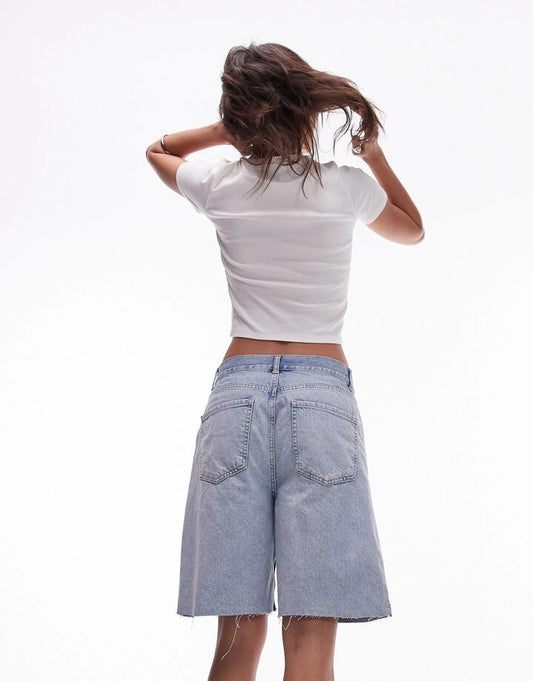 Image of a model wearing Denim. Productname: Topshop Denim Loose fit jort in Bleach Blue colour by brand - Topshop