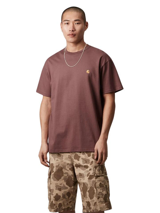 Image of a model wearing Shorts. Productname: Carhartt Wip Short Sleeve Chase T-Shirt in Dusky Pink/Gold colour by brand - Carhartt Wip