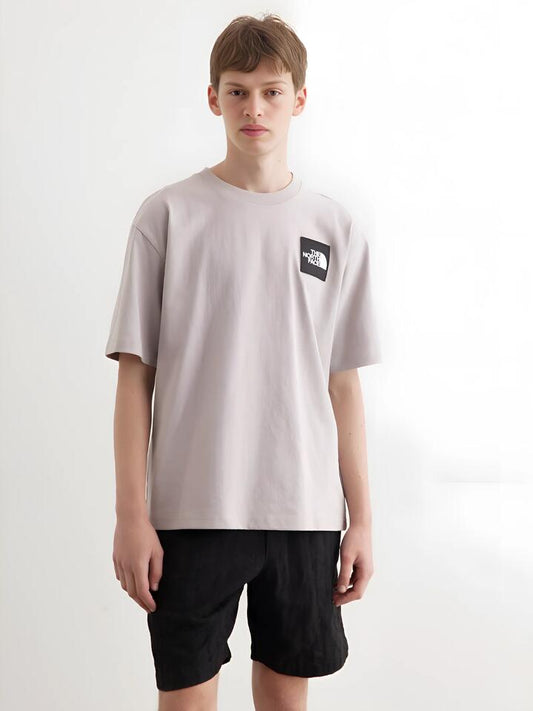 Image of a model wearing Tops. Productname: The North Face Heavyweight Box Fit Tee in MOONSTONE GREY colour by brand - The North Face