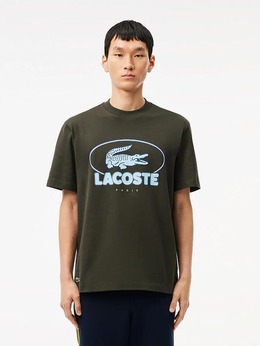 Image of a model wearing Tops. Productname: Lacoste Transitional Logo T-Shirt in Black colour by brand - Lacoste
