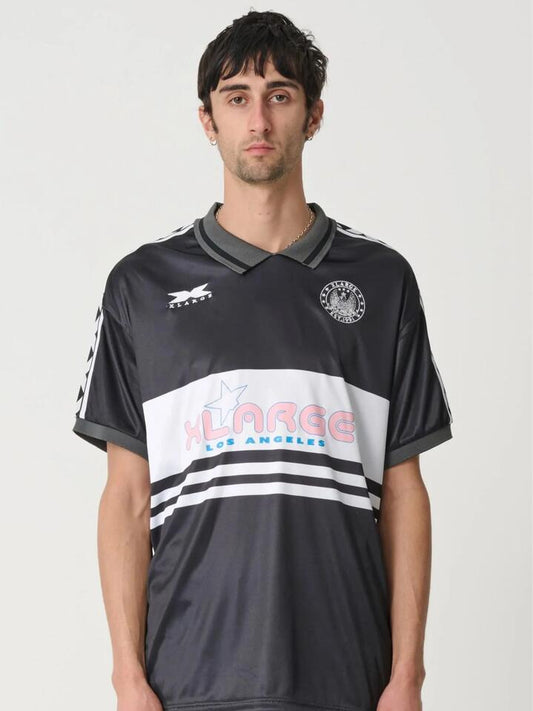 Image of a model wearing Tops. Productname: Xlarge XL Star Football SS Tee in BLACK colour by brand - Xlarge