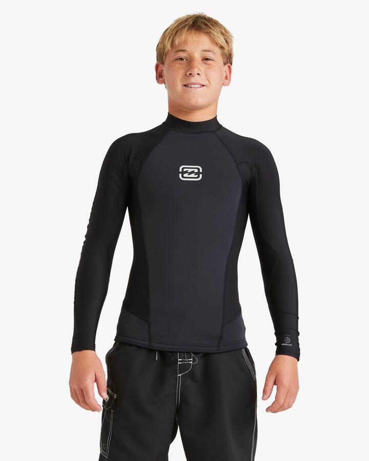 Image of a model wearing Tops. Productname: Billabong - Boys 6-16 1Mmabsolute Natural Poly Long Sleeve Wetsuit Top - Black - in Black colour by brand - Billabong