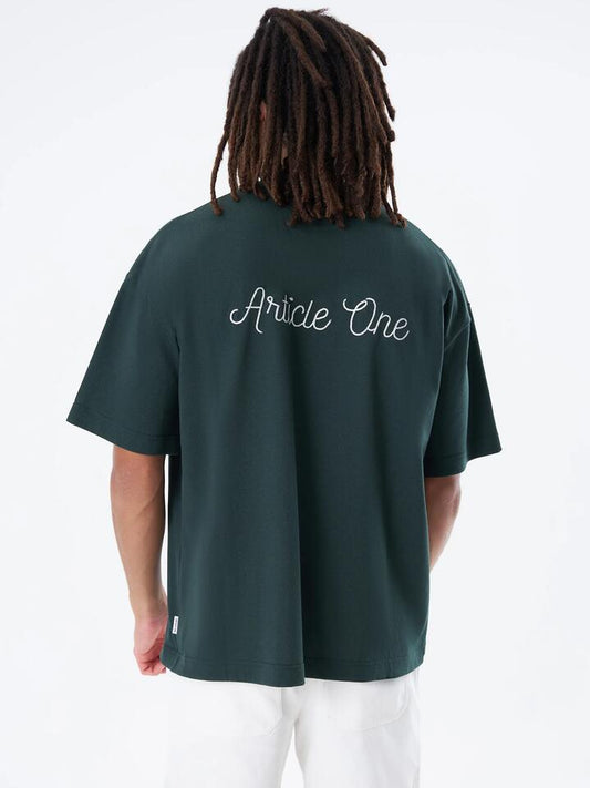 Image of a model wearing Tops. Productname: Article One Chainstitch Logo Tee in College Green colour by brand - Article One