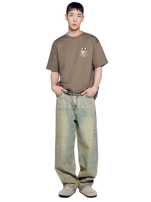 Image of a model wearing Shorts. Productname: ADLV Rabbit Bear Doll Logo Short Sleeve T-Shirt in COCOA colour by brand - ADLV