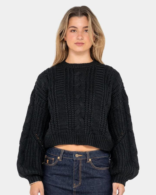 Image of a model wearing Outerwear. Productname: Rusty - Womens Folktale Crop Chunky Knitted Sweatshirt - Black - in Black colour by brand - Rusty