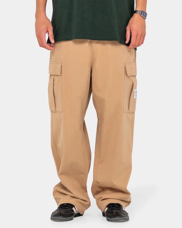Image of a model wearing Pants. Product name - Rusty Mens Commando Cargo Pants Light Khaki in Light Khaki colour by brand - Rusty
