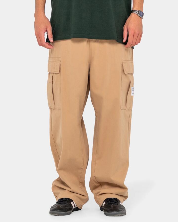 Image of a model wearing Pants. Product name - Rusty Mens Commando Cargo Pants Light Khaki in Light Khaki colour by brand - Rusty