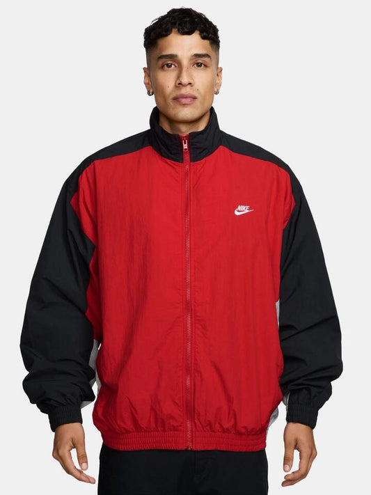 Image of a model wearing Outerwear. Productname: Nike Club Woven Track Jacket in University Red colour by brand - Nike