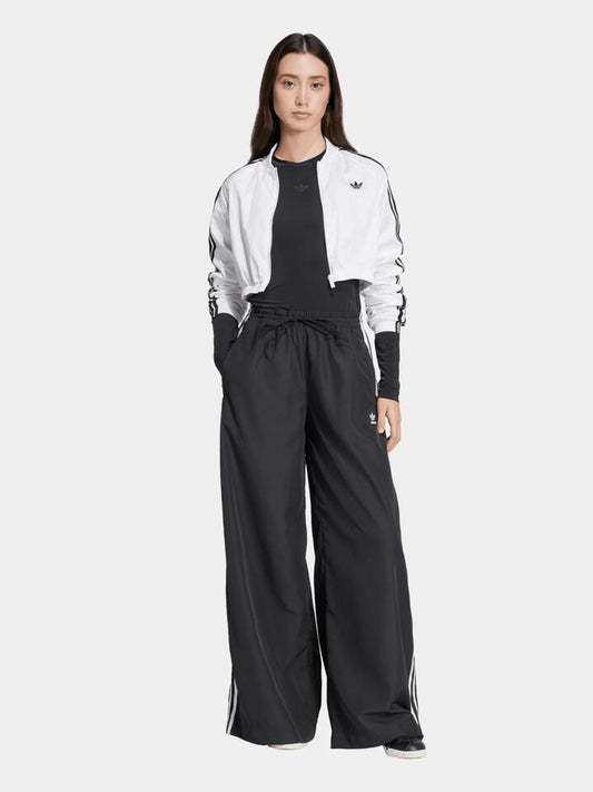 Image of a model wearing Pants. Productname: Adidas Oversized Track Pant in BLACK colour by brand - Adidas