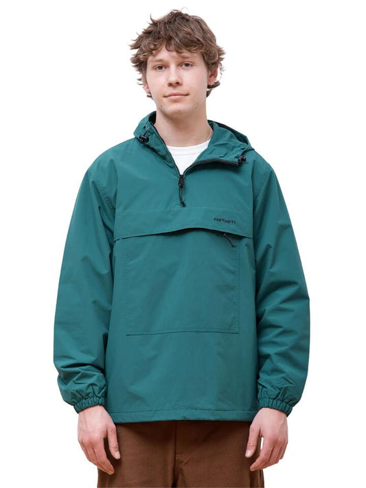Image of a model wearing Outerwear. Productname: Carhartt Wip Windbreaker Pullover in Chervil/Black colour by brand - Carhartt Wip