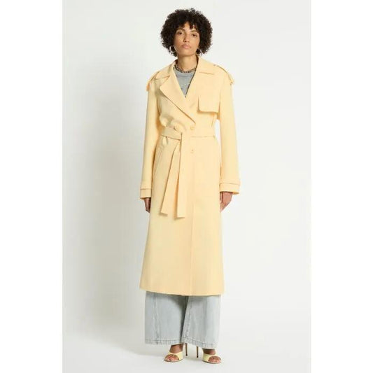 Image of a model wearing Outerwear. Productname: Nero Trench in BUTTER colour by brand - sass and bide