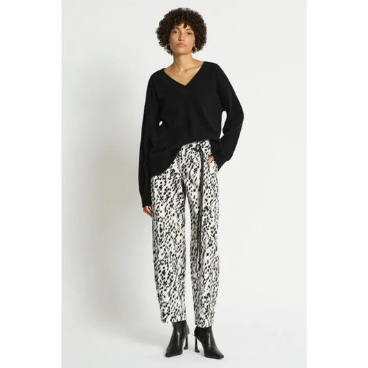 Image of a model wearing Tops. Productname: Lucillian V Neck Knit Top in Black colour by brand - sass and bide