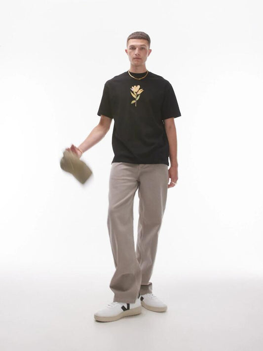 Image of a model wearing Tops. Productname: Topman Premium Oversized T-Shirt with Lily Print in Black colour by brand - Topman