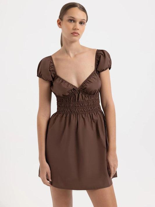 Image of a model wearing Dress. Productname: Lulu & Rose Savannah Mini Dress in Mocha colour by brand - Lulu & Rose
