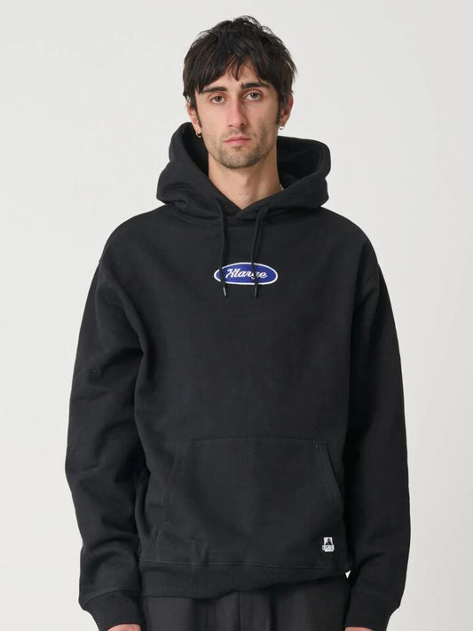 Image of a model wearing Outerwear. Productname: Xlarge Oval Script Hood in Black colour by brand - Xlarge