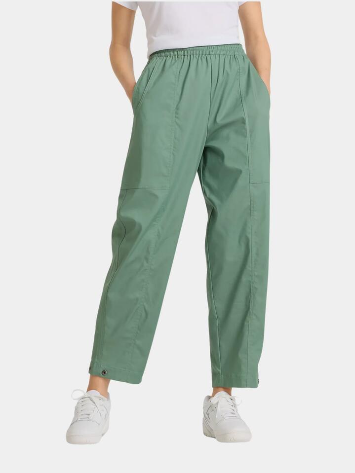 Image of a model wearing Pants. Productname: New Balance Utility Pant in Dark Juniper colour by brand - New Balance