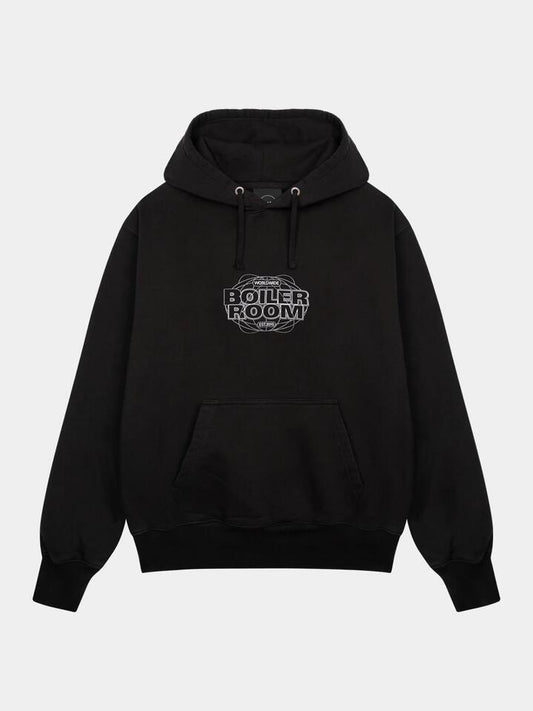 Image of a model wearing Outerwear. Productname: Boiler Room World Tour Hood in Black colour by brand - Boiler Room