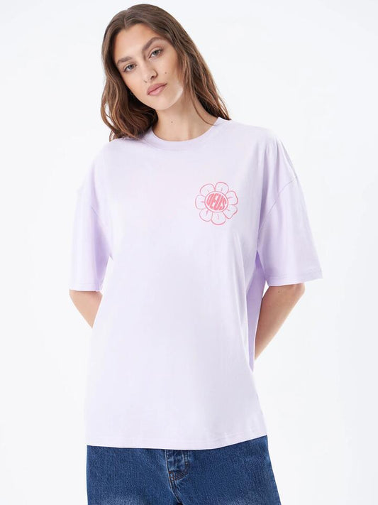 Image of a model wearing Tops. Productname: Deus Swing It Low Tee in Orchid Hush colour by brand - Deus