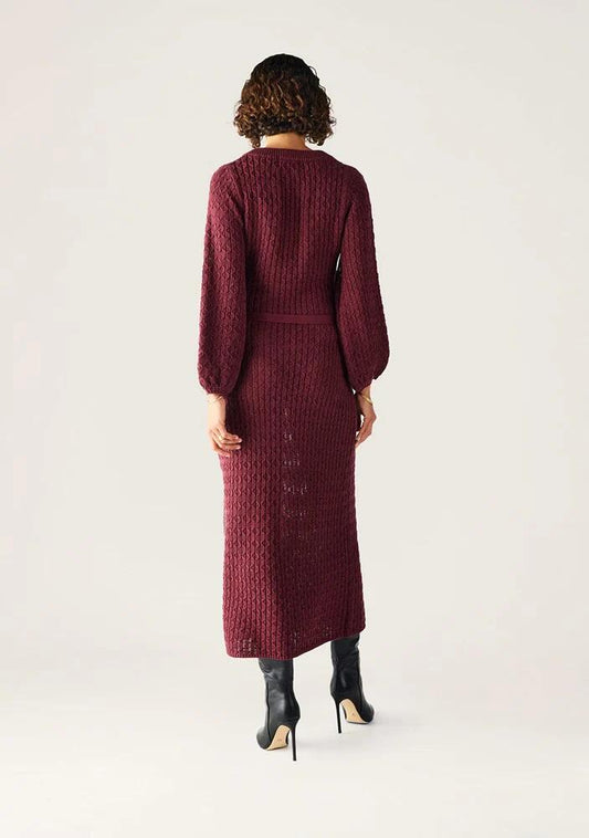 Image of a model wearing Dress. Productname: Furilia Knit Maxi Dress in Cherry Lacquer colour by brand - MOS The Label