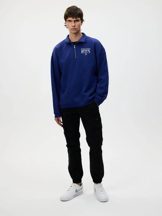 Image of a model wearing Outerwear. Productname: Henleys Midnight Sapphire Quarter Zip in Navy colour by brand - Henleys