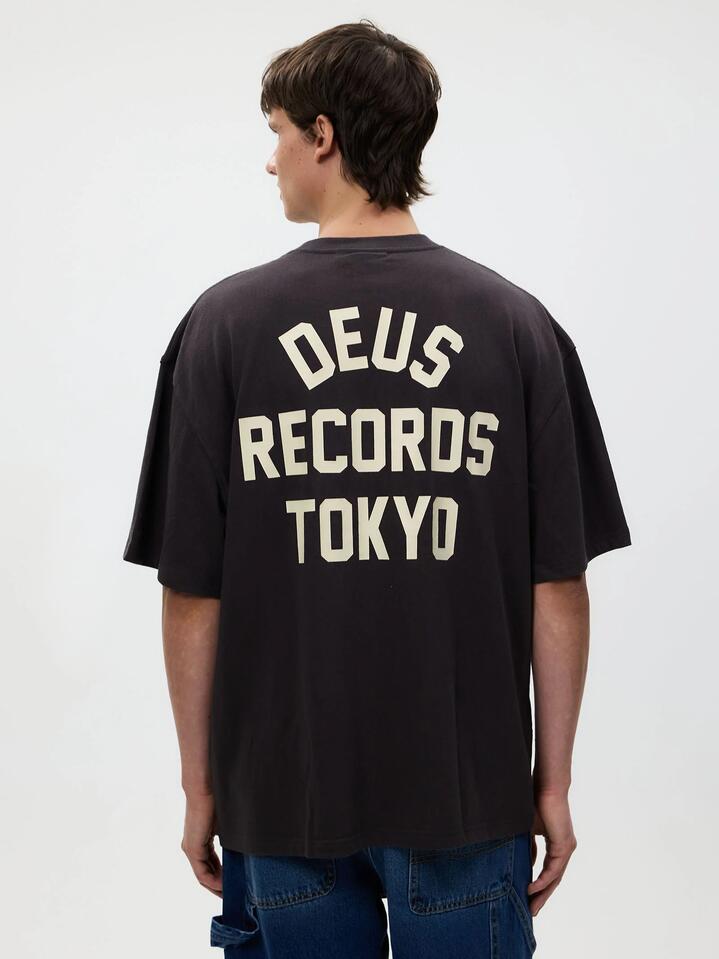 Image of a model wearing Tops. Productname: Deus Drive Far Away Tee in Anthracite colour by brand - Deus