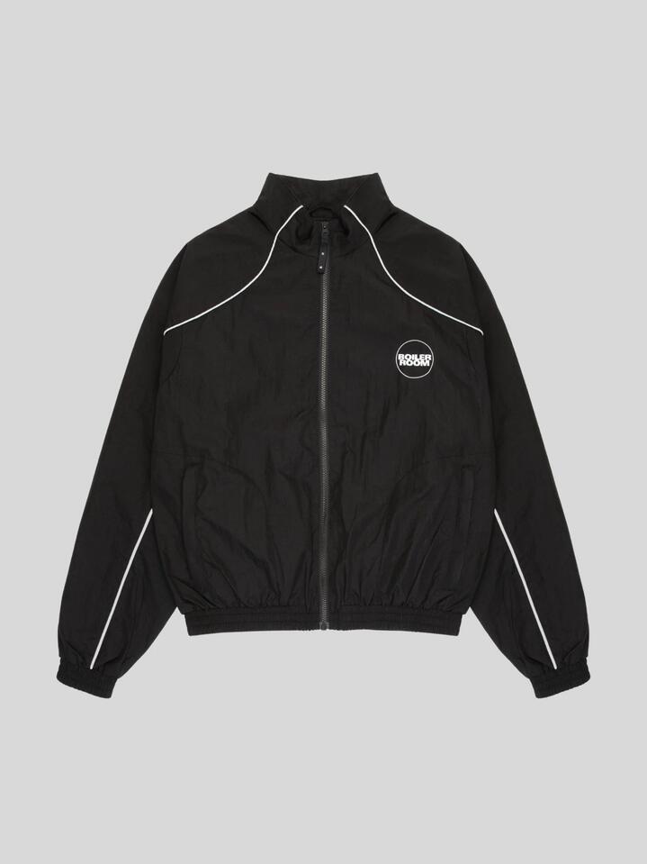 Image of a model wearing Tops. Productname: Boiler Room Shell Track Top in BLACK colour by brand - Boiler Room