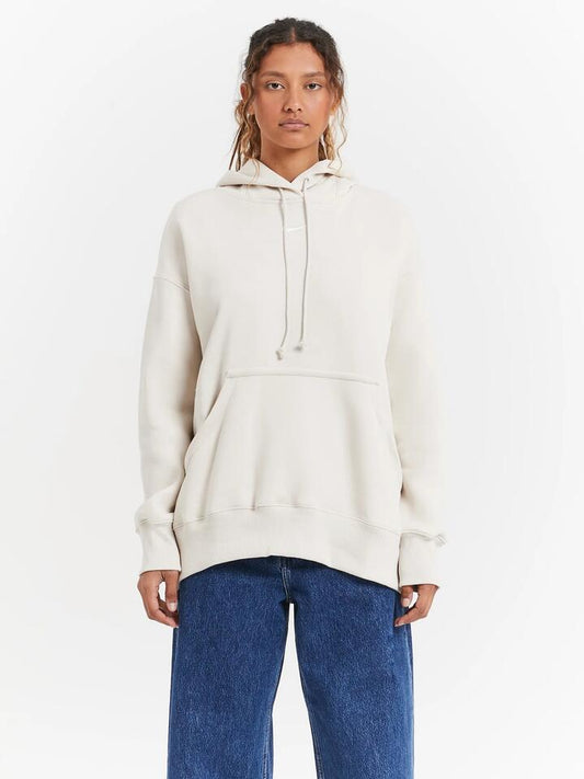Image of a model wearing Outerwear. Productname: Nike Sportswear Phoenix Fleece Oversized Pullover Hoodie in Light Orewood Brown Sail colour by brand - Nike