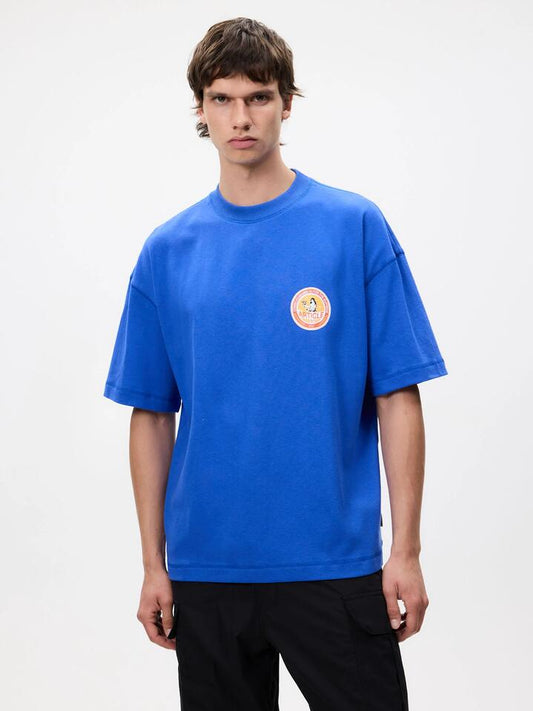 Image of a model wearing Tops. Productname: Article One Supreme Tee in Cobalt colour by brand - Article One