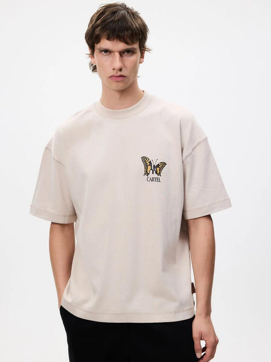 Image of a model wearing Tops. Productname: Weekend Cartel Butterfly Tee in Beige colour by brand - Weekend Cartel