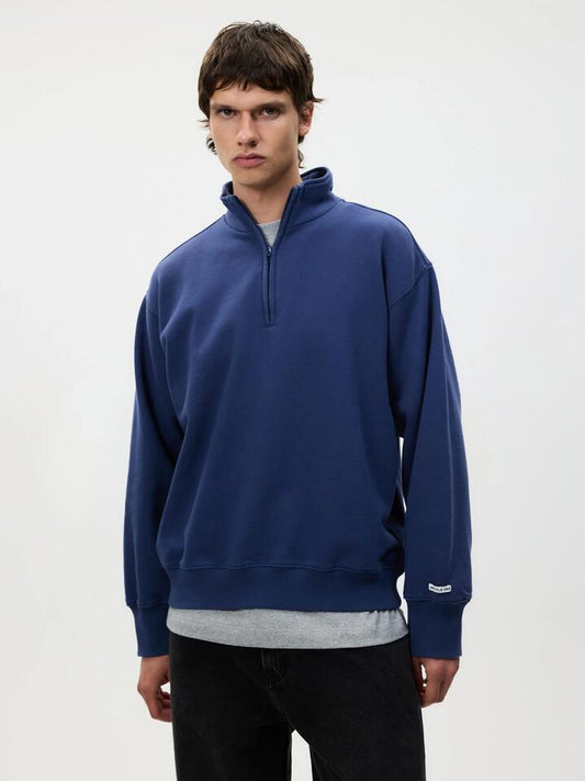 Image of a model wearing Outerwear. Productname: Article One Article Rose 1/4 Zip in Navy colour by brand - Article One