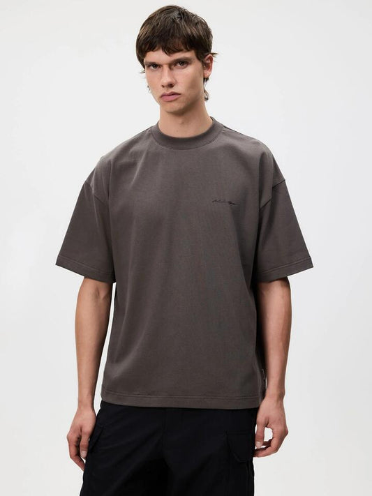 Image of a model wearing Tops. Productname: Article One Tuscany Tee in Washed Black colour by brand - Article One