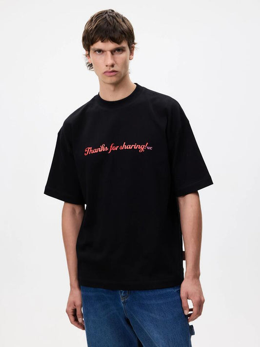 Image of a model wearing Tops. Productname: Weekend Cartel Sharing Tee in Black colour by brand - Weekend Cartel
