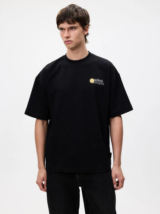 Image of a model wearing Tops. Productname: Weekend Cartel Space Tee in Black colour by brand - Weekend Cartel