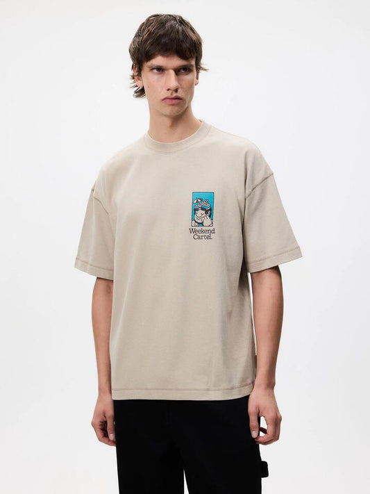 Image of a model wearing Tops. Productname: Weekend Cartel Weekend Tee in Oatmeal colour by brand - Weekend Cartel