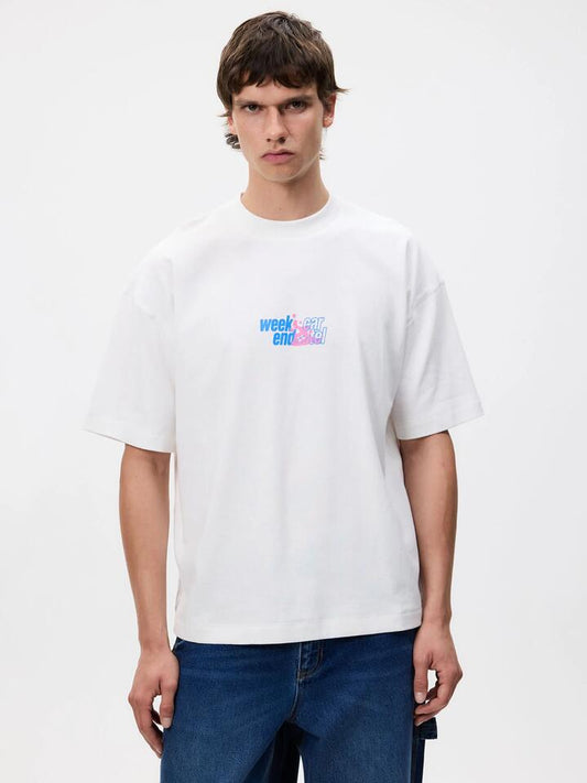 Image of a model wearing Tops. Productname: Weekend Cartel Less is More Tee in White colour by brand - Weekend Cartel