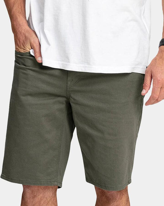 Image of a model wearing Shorts. Productname: Volcom - Mens Solver Lite 5 Pocket 19" Walk Shorts - Army Green Combo - in Army Green Combo colour by brand - Volcom