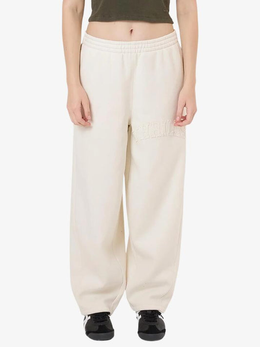 Image of a model wearing Pants. Productname: Thrills Home Advantage Track Pant in Tofu colour by brand - Thrills