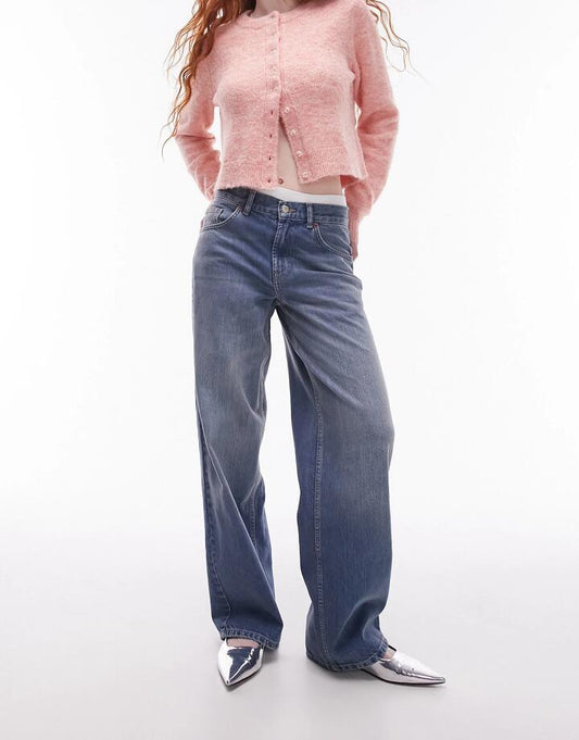 Image of a model wearing Denim. Productname: Topshop Low Rise Cinch Back Jeans in MID BLUE colour by brand - Topshop