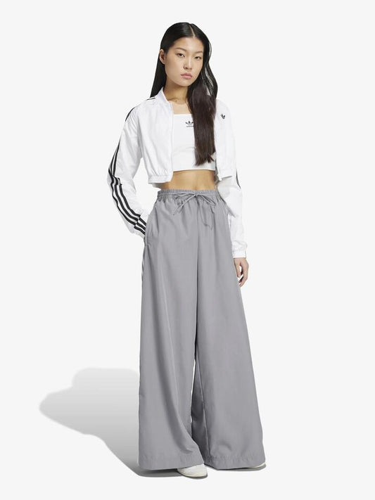 Image of a model wearing Pants. Productname: Adidas Oversized Track Pant in GREY THREE colour by brand - Adidas