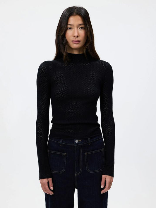 Image of a model wearing Tops. Productname: Lulu & Rose Solene High Neck Knit Top in Black colour by brand - Lulu & Rose