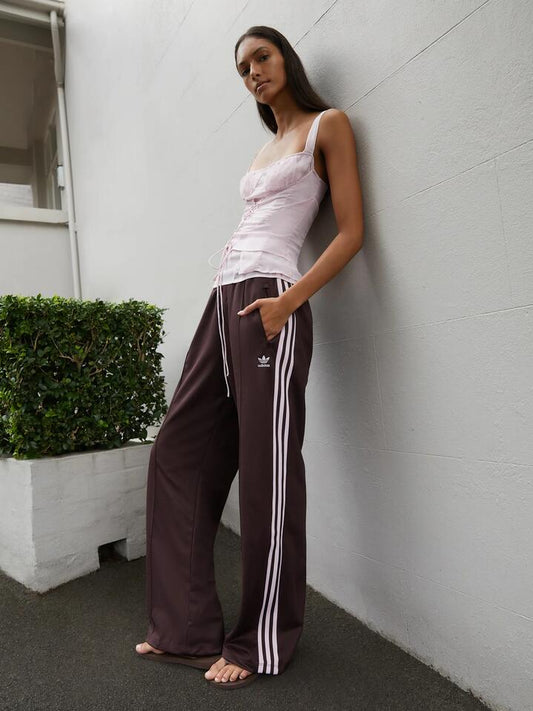 Image of a model wearing Pants. Productname: Adidas Beckenbauer Track Pants in Shadow Brown colour by brand - Adidas