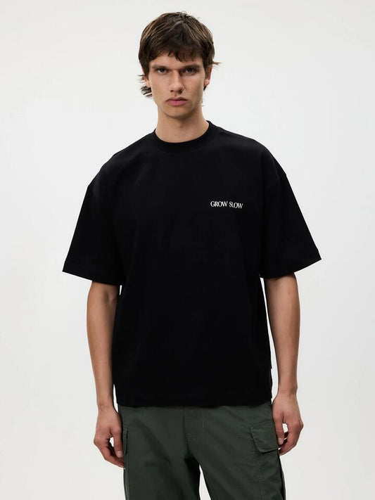 Image of a model wearing Tops. Productname: Article One Vine Tee in WASHED BLACK colour by brand - Article One