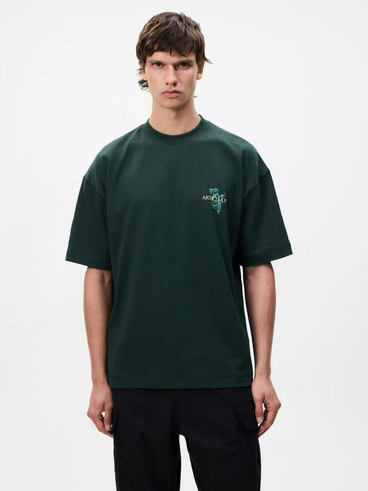 Image of a model wearing Tops. Productname: Article One Ceremony Tee in Forest colour by brand - Article One