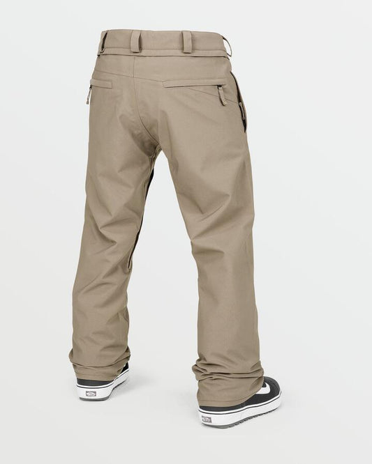 Image of a model wearing Pants. Productname: Volcom Mens Freakin Snow Chino Snow Pants Chestnut Brown - in Chestnut Brown colour by brand - Volcom
