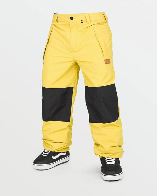 Image of a model wearing Pants. Product name - Volcom Mens Longo Gore-Tex Snow Pants Dark Yellow in Dark Yellow colour by brand - Volcom