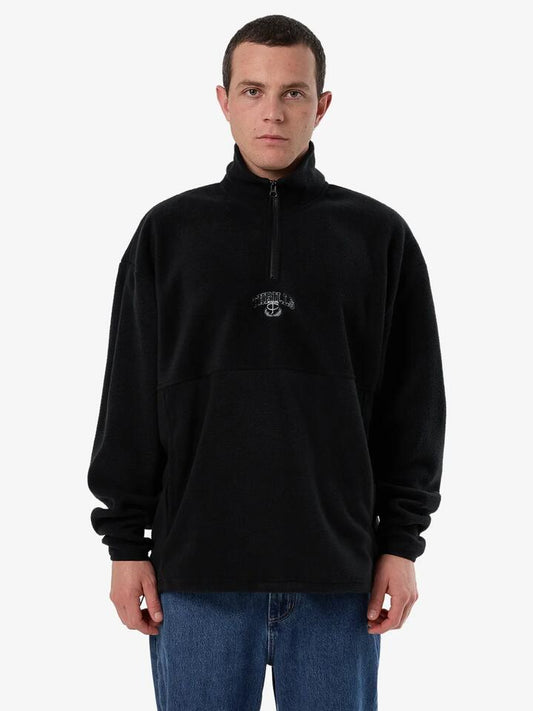 Image of a model wearing Outerwear. Productname: Thrills Legacy Wreath Quarter Zip Polar Fleece in Black colour by brand - Thrills