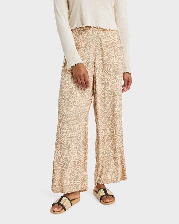 Image of a model wearing Pants. Product name - Roxy Womens Midnight Avenue Pants Parchment Animal Floral in Parchment Animal Floral colour by brand - Roxy